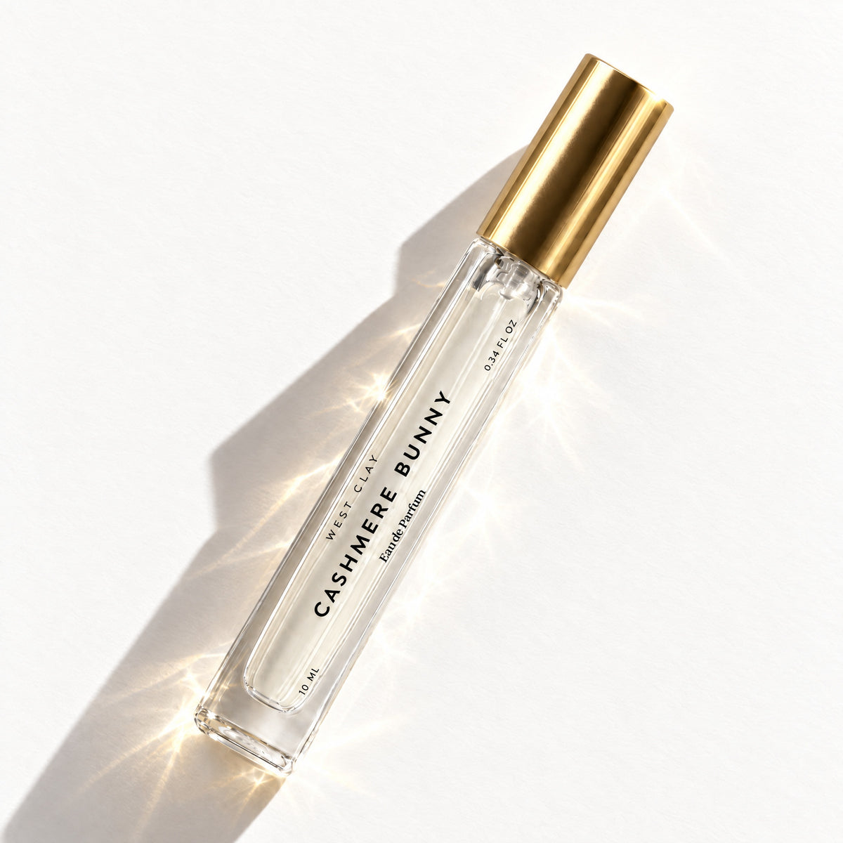 Cashmere Bunny Eau de Parfum by West Clay, 10 mL travel size flash flat lay studio photo