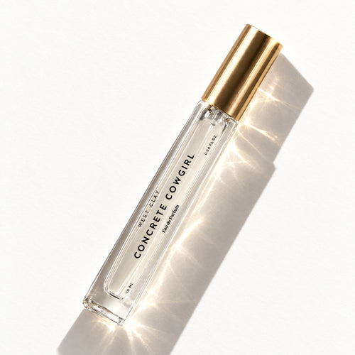 Concrete Cowgirl Eau de Parfum by West Clay, 10 mL travel size flash flat lay studio photo