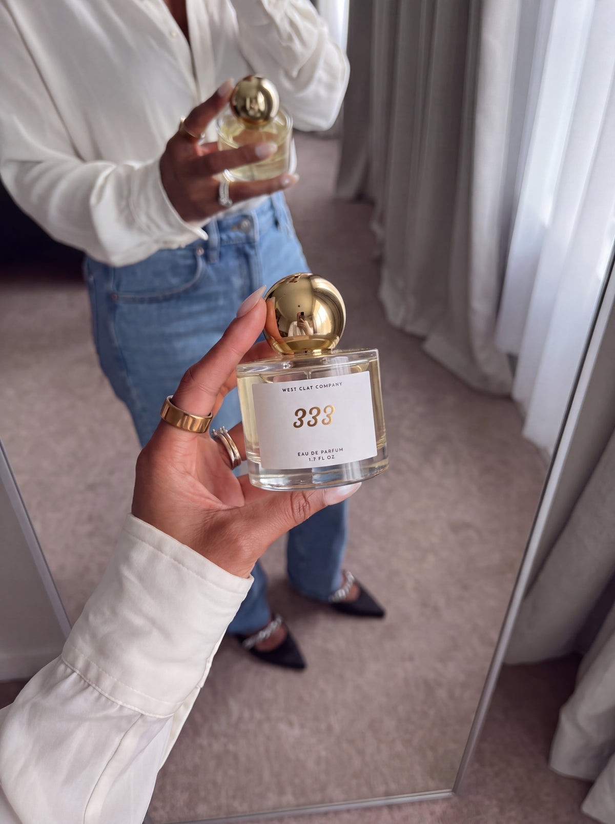Getting ready with West Clay 333 perfume in the mirror